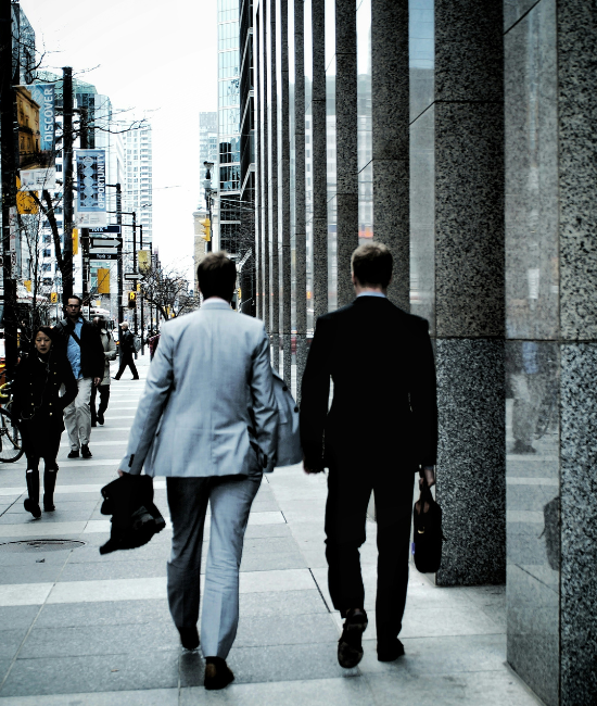 Digital Marketing Success Journey Two men walking side by side on a city sidewalk, engaged in conversation
